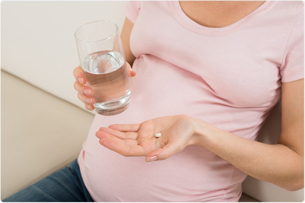 Woman taking iron supplement