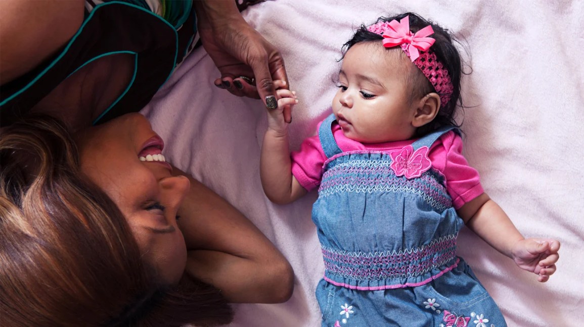 Baby girl and mom on bed