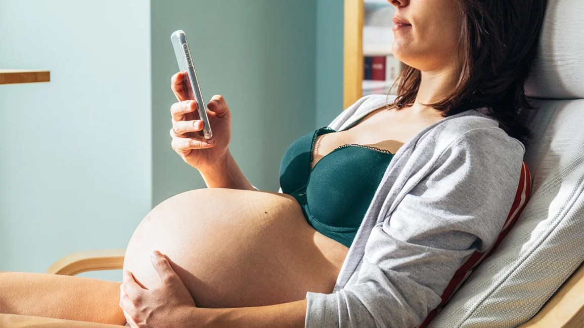 Pregnant woman looking at phone